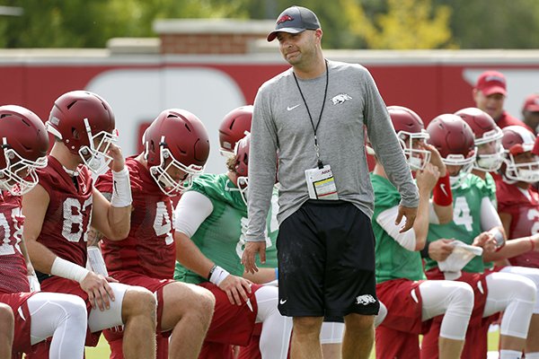 Arkansas tight ends coach Barry Lunney Jr. talks to players during warmups prior to practice Thursday, July 27, 2017, in Fayetteville. 
