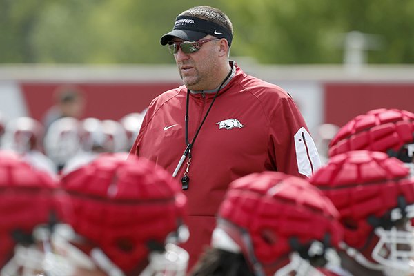 Arkansas coach Bret Bielema watches warmups prior to practice Thursday, July 27, 2017, in Fayetteville.