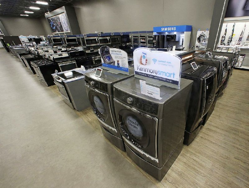 In this Thursday, July 20, 2017, file photo, the Kenmore Elite Smart Electric Dryer and Front Load Washer, center, appears on display at a Sears store, in West Jordan, Utah. On Thursday, July 27, 2017, the Commerce Department releases its report on durable goods for June. 