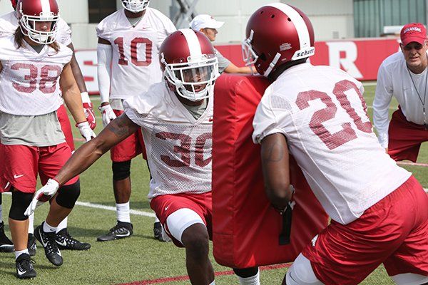 Arkansas defensive back Kevin Richardson (30) goes through tackling drills during practice Friday, July 28, 2017, in Fayetteville. 