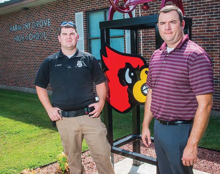 Joseph West, left, the new school resource officer for the Harmony Grove School District, stands next to superintendent Heath Bennett in front of the high school. West is the first resource officer in the school’s history.