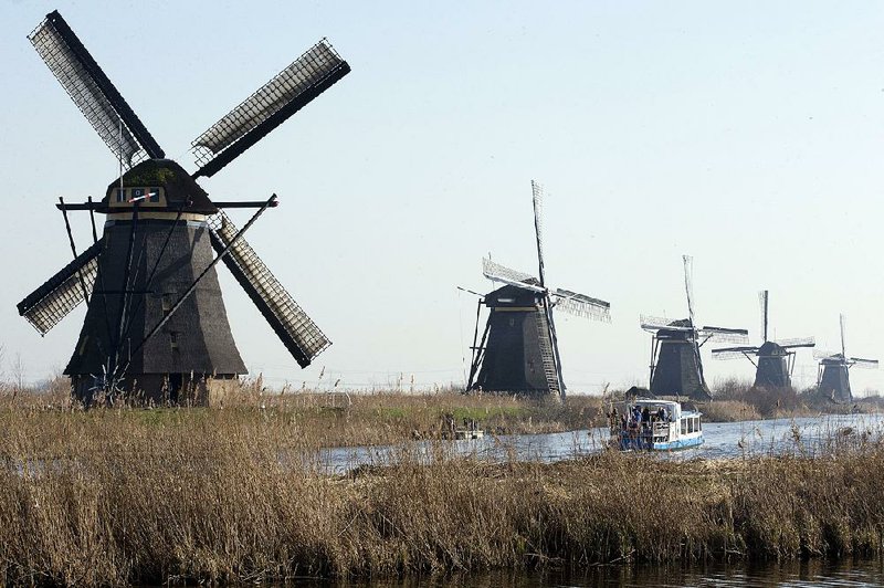 Windmills lining the Hooge Boezem van de Overwaard canal at the UNESCO World Heritage site in Kinderdijk, Netherlands, are major draws for tourists.