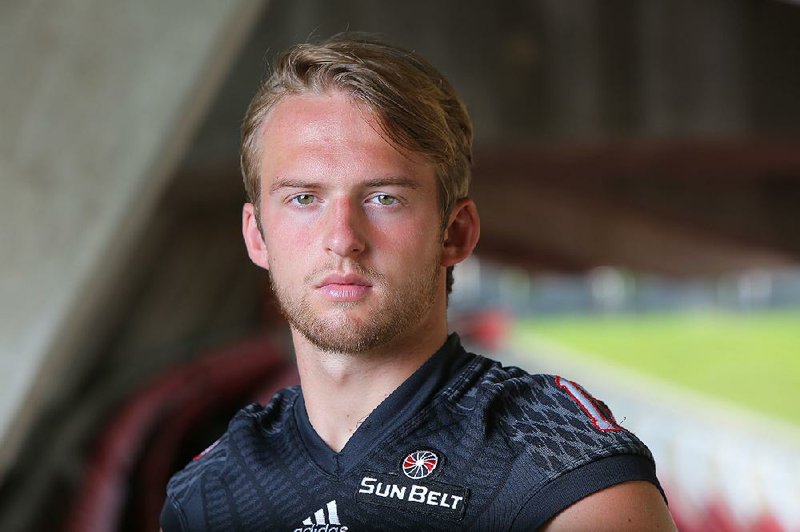 Arkansas State junior quarterback Justice Hansen (center) is one of five returning starters on offense. Hansen passed for 2,719 yards and 19 touchdowns last season.