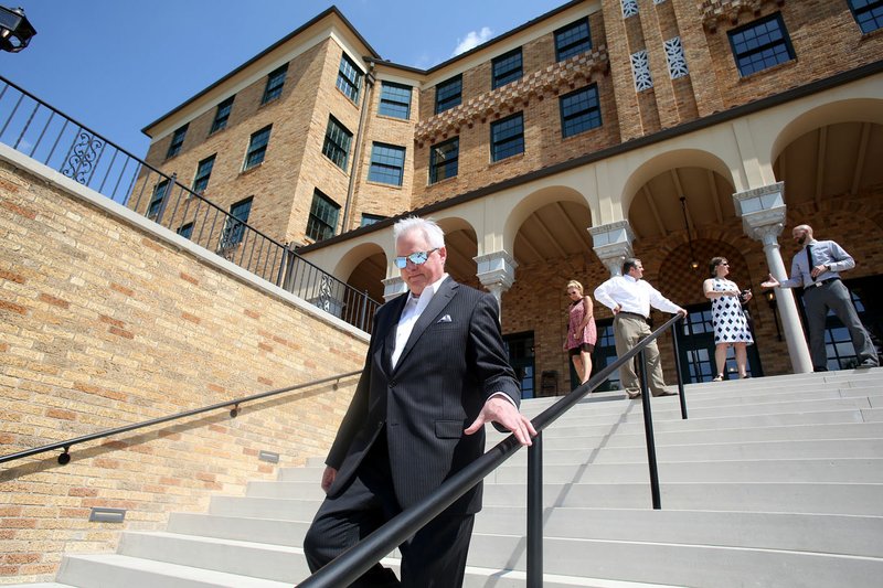 Martin Schoppmeyer, superintendent of Haas Hall Academy, walks Tuesday down the south steps of the new Haas Hall Academy Rogers Campus in Rogers. The campus is in the former Lane Hotel in the Rogers Commercial Historic District.