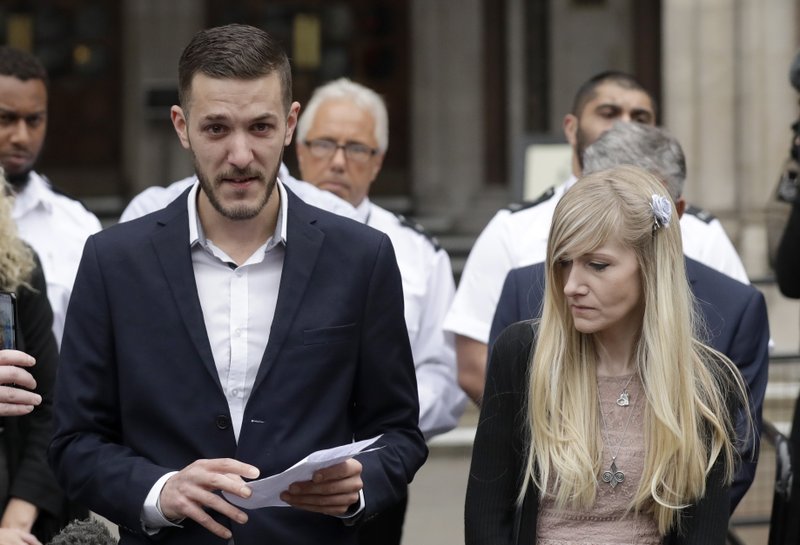 FILE - In this file photo dated Monday, July 24, 2017, Chris Gard, the father of critically ill baby Charlie Gard reads a statement next to mother Connie Yates, right, at the end of their case at the High Court in London. British media are reporting a family announcement that 11-month old Charlie Gard, has died Friday July 28, 2017. (AP Photo/Matt Dunham, FILE)
