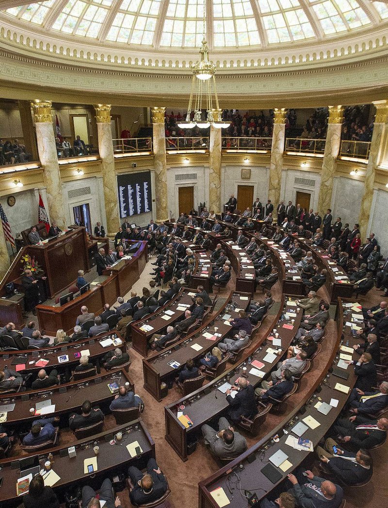 Gov. Asa Hutchinson addresses a joint session of the state Legislature on Jan. 10. Hundreds of new laws passed during the 91st General Assembly take effect Tuesday. 