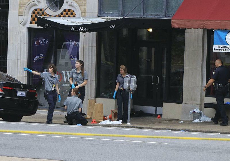 Little Rock Police Department crime scene personnel collect evidence July 1, 2017, after a shooting at the Power Ultra Lounge at 220 W. Sixth St. 