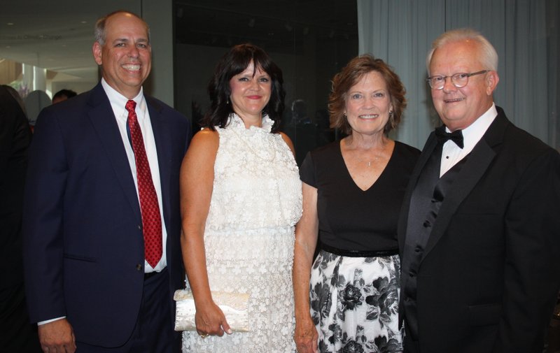 NWA Democrat-Gazette/CARIN SCHOPPMEYER Larry and Julie Shackelford (from left) and Stephanie and Bill Bradley, Washington Regional Medical System chief executive officer and Vision Award recipient, gather at the 23rd Washington Regional Gala on July 15 at the Walton Arts Center in Fayetteville.