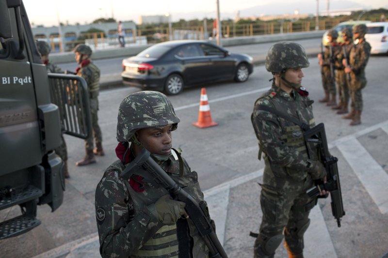 Soldiers patrol a highway near the Mare Complex slum in Rio de Janeiro, Brazil, Friday, July 28, 2017. Thousands of Brazilian soldiers have begun patrolling in Rio de Janeiro amid a spike in violence. (AP Photo/Silvia Izquierdo)