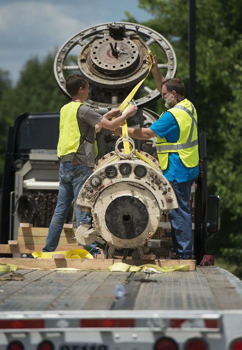 Colt Longnecker (left) and Clint Branham with Supporting STEM & Space rig a section of telescope with lifting straps Saturday as volunteers unload the giant telescope for temporary storage at 8th Street Market in Bentonville. Swarthmore College in Swarthmore, Pa., donated the 106-year-old telescope to Supporting STEM & Space, a Northwest Arkansas nonprofit, in April on the stipulation that the nonprofit would pay for transport.