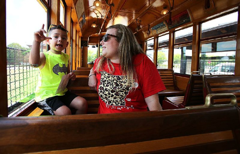 Jackson Thurig, 4, talks with his mother, Beth, while they ride a Rock Region Metro streetcar on July 21.