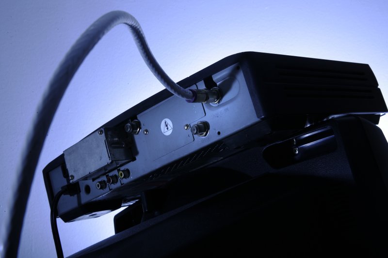 FILE - This Wednesday, May 30, 2007, file photo shows a cable box on top of a television set in Philadelphia. (AP Photo/Matt Rourke, File)