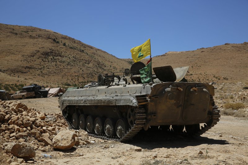 A Hezbollah armored vehicle sits at the site where clashes erupted between Hezbollah and al-Qaida-linked fighters in Wadi al-Kheil or al-Kheil Valley in the Lebanon-Syria border, Saturday, July 29, 2017.