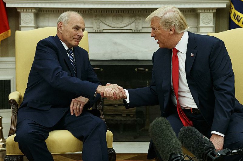 President Donald Trump talks with new White House Chief of Staff John Kelly after he was privately sworn in during a ceremony in the Oval Office on Monday in Washington.