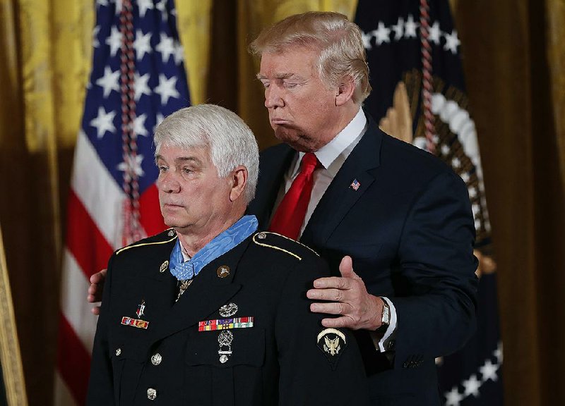 President Donald Trump bestows the nation’s highest military honor on former Army medic James McCloughan on Monday at the White House.