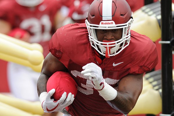 Arkansas running back David Williams carries the ball Tuesday, Aug. 1, 2017, during practice at the university's practice field in Fayetteville.
