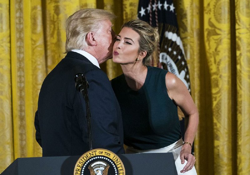 President Donald Trump exchanges a kiss Tuesday with his daughter Ivanka during an event with small-business leaders in the East Room of the White House.  