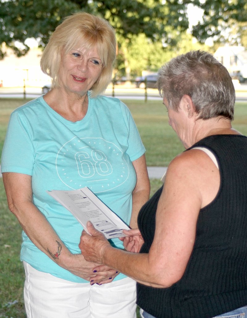 Photo by Randy Moll Paula Moray was inducted as a new Gentry Lions Club member by out-going president Roberta DeFraga on July 24 at a special meeting in the city park.