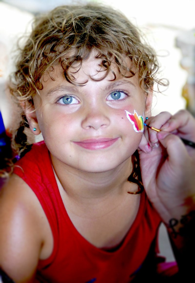 Photo by Randy Moll Naomi Cruz, 6, had her face painted in the Gentry City Park during the July 24 final session of the Gentry Public Library summer reading program.