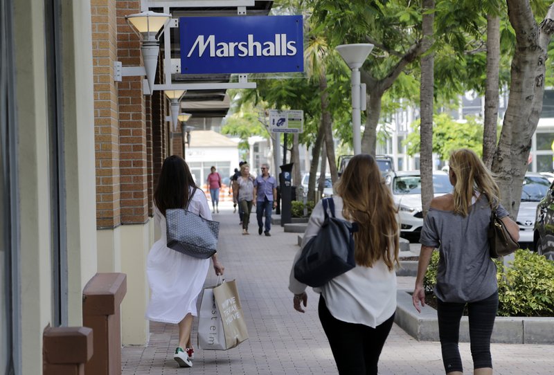 In this Friday, May 19, 2017, photo, shoppers walk past a Marshalls store in Miami. Consumer spending slowed in June as income growth turned in the weakest performance in seven months, according to information released Tuesday, Aug. 1, 2017, by the Commerce Department. (AP Photo/Lynne Sladky)