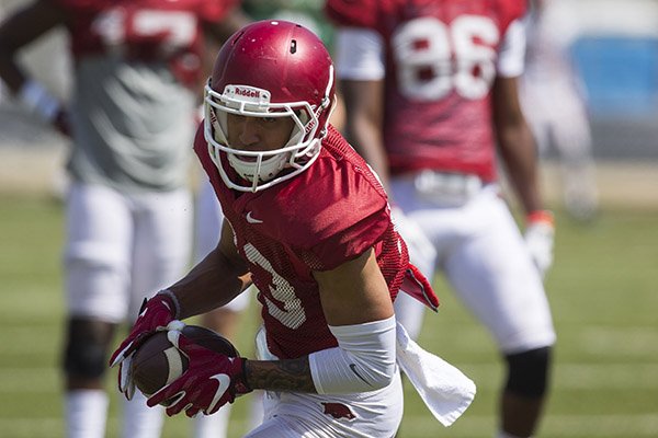 Arkansas receiver Deon Stewart runs after the catch during practice Saturday, April 15, 2017, in Fayetteville. 