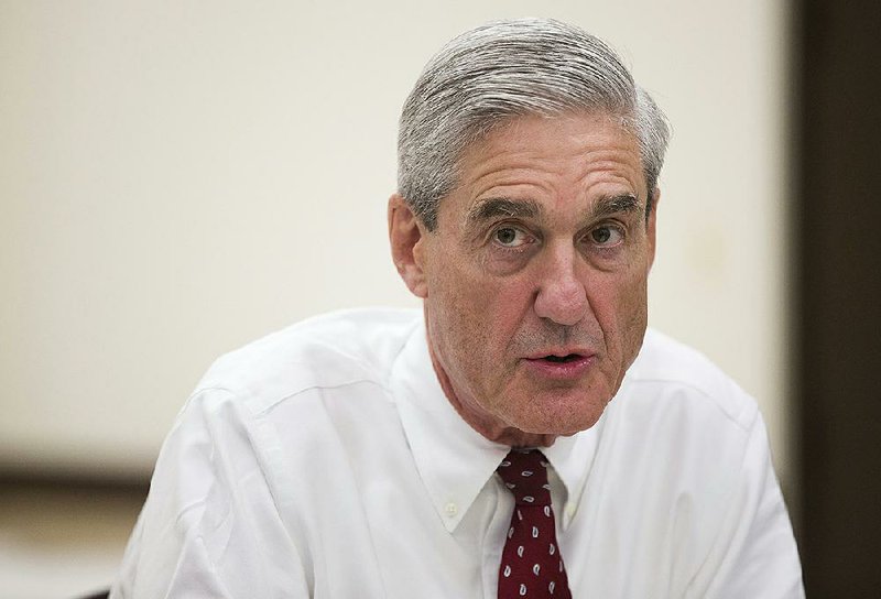 In an Aug. 21, 2013 file photo, outgoing FBI director Robert Mueller speaks during an interview at FBI headquarters, in Washington.