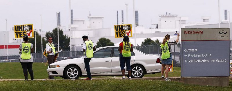 United Auto Workers representatives set up outside an employee entrance at the Nissan vehicle assembly plant in Canton, Miss., on Tuesday. Workers began voting Thursday on whether to join the union.  