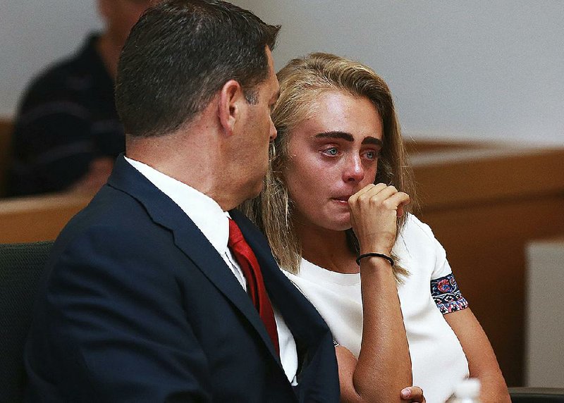 Michelle Carter awaits her sentencing Thursday in a courtroom in Taunton, Mass., for encouraging Conrad Roy III to kill himself in July 2014. Carter was sentenced to 15 months in jail.