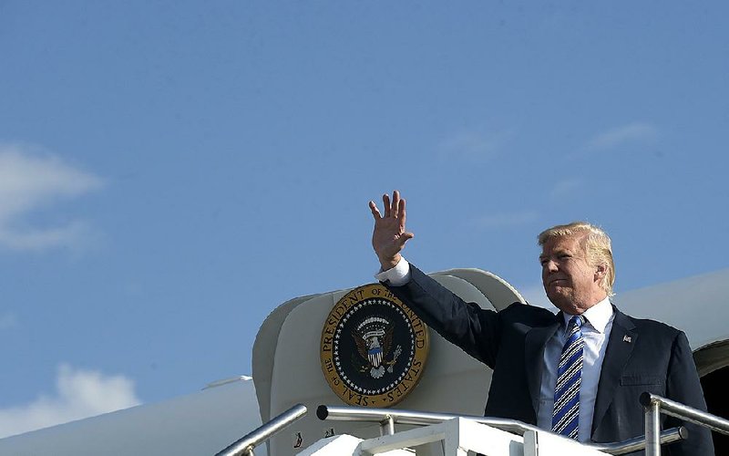 President Donald Trump disembarks Thursday from Air Force One in Huntington, W.Va. Trump will begin his first extended vacation from Washington today.