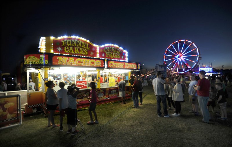 Visitors wait in line to buy food in the midway during the 2016 Washington County Fair.