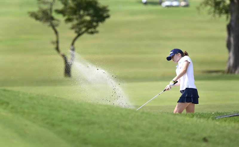 NWA Democrat Gazette/SPENCER TIREY Greenwood's Ella Austin chips out of the sand on hole No. 1 Thursday at the Springdale Country Club.