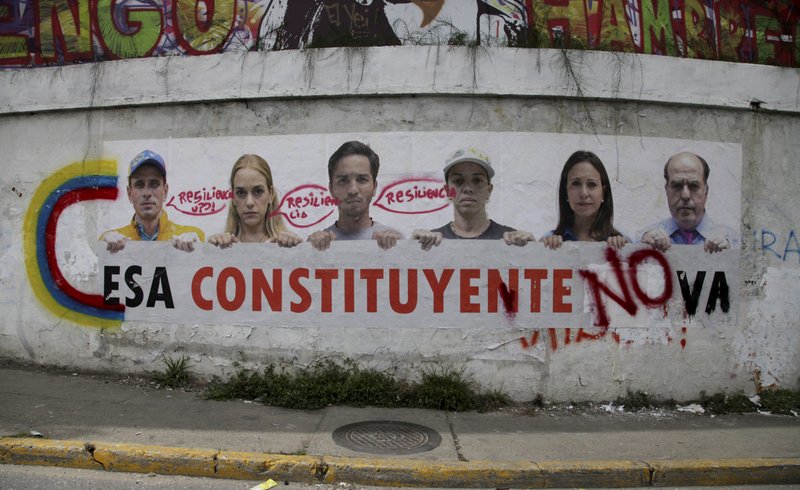 A poster that shows some of Venezuela's opposition leaders holding a sign with a message that reads in Spanish: "That constituent assembly will not pass"is displayed on a wall near Altamira Square in Caracas, Venezuela, Thursday, Aug. 3, 2017. 