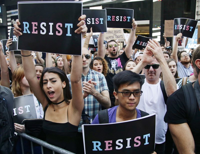 In this July 26, 2017, file photo, protestors attend a rally in New York City, to protest President Donald Trump's announcement of a ban on transgender troops serving anywhere in the U.S. military. 