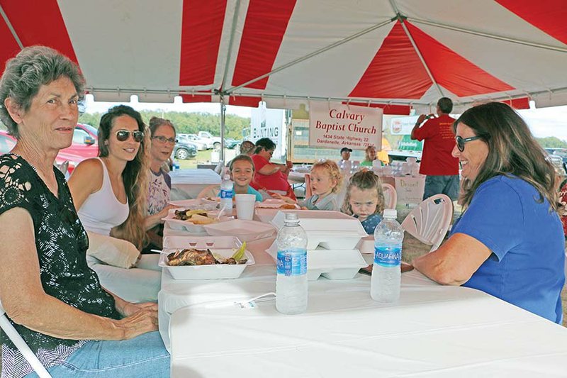 Eating chicken dinners at the 2016 Mount Nebo Chicken Fry are, from left, Judy Konkel, Brittney Bunting, Christie Talley, Talley Caldwell, twins Dax and Mercy Bunting and Kay Daugherty. The 2017 event is Saturday.