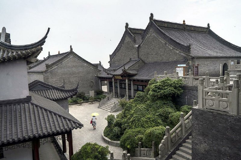 A visitor walks through the new temple complex at Mao Mountain, an eco-friendly temple meant to stand counter to the pollution and consumerist culture that surrounds it. 
