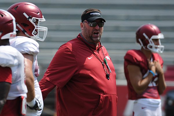 Arkansas coach Bret Bielema talks to players during practice Saturday, Aug. 5, 2017, in Fayetteville. 