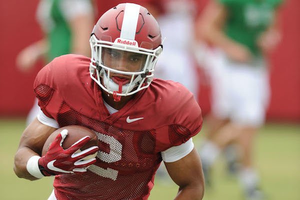 Arkansas running back Chase Hayden carries the ball Tuesday, Aug. 1, 2017, during practice at the university's practice field in Fayetteville.