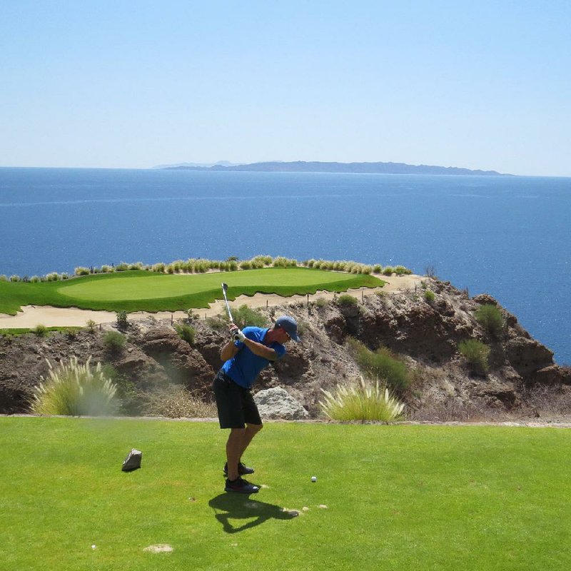 Brandon Hendricks of Long Beach, Calif., tees off on the signature 17th hole at Danzante Bay Golf Club at Villa del Palmar Resort at the Islands of Loreto, Mexico. He parred the hole.  