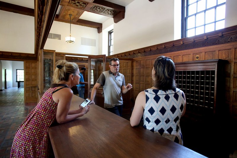 Joi Knight (from left), director of development with Haas Hall Academy; David Swain, project manager; and Stacy Keenan, director of development, speak July 25 in the restored lobby area at the new Haas Hall Academy Rogers Campus in Rogers. The campus is in the former historic Lane Hotel in the Rogers Commercial Historic District.