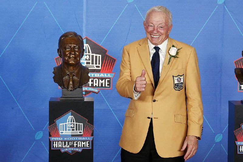 Dallas Cowboys owner Jerry Jones poses with a bust of him during inductions at the Pro Football Hall of Fame on Saturday, Aug. 5, 2017, in Canton, Ohio. 