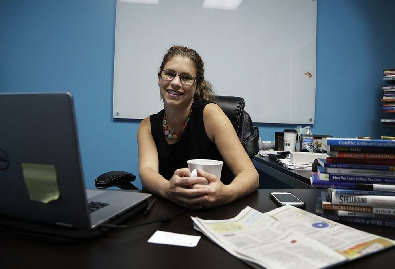 Becky Robinson poses for a picture in her marketing company office in Lambertville, Mich., late last month.
