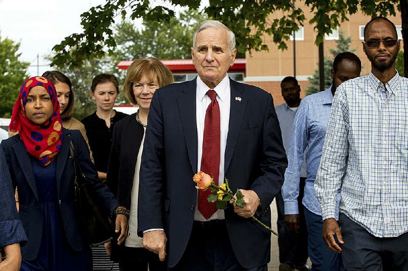 Minnesota Gov. Mark Dayton appears Sunday at the Dar Al Farooq Islamic Center in Bloomington, Minn., where an explosion damaged a room and shattered windows as worshippers prepared for morning prayers early Saturday.
