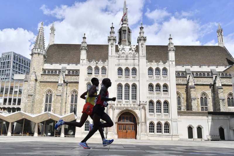 Kenya's Geoffrey Kipkorir Kirui, right, leads Ethiopia's Tamirat Tola past the Guildhall on his way to winning the gold medal in the Men's Marathon during the World Athletics Championships Sunday, Aug. 6, 2017. 