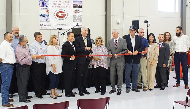 Photo by Randy Moll
Arkansas Governor Asa Hutchinson cut the ribbon to open the new Gentry Career and Technical Education Center at the high school on Tuesday, Aug. 8. Joining him were Rep. Steve Womack, teachers, school administrators and staff, school board members, Gentry's mayor and Chamber of Commerce members, and the building's designers and engineers.