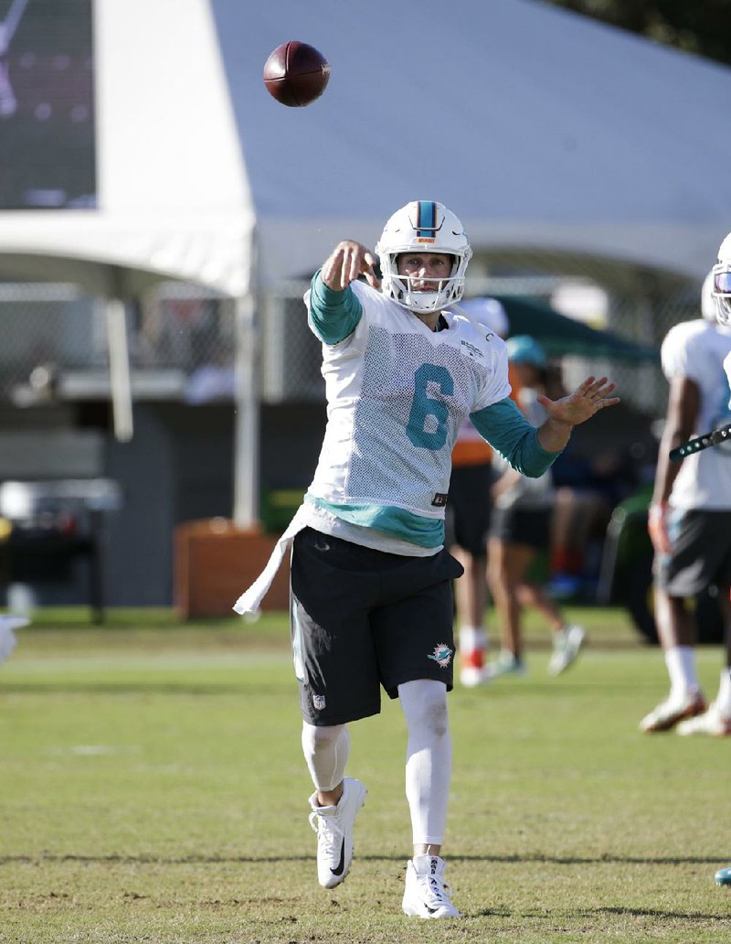 Miami Dolphins quarterback Jay Cutler goes through drills with his new team Tuesday. The Dolphins signed Cutler, who had retired in the offseason, to a one-year contract Sunday.