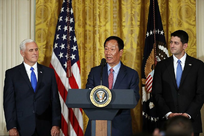 Terry Gou, president and chief executive officer of Foxconn, accompanied by Vice President Mike Pence (left) and House Speaker Paul Ryan, R-Wisconsin, speaks in the East Room of the White House on July 26. 