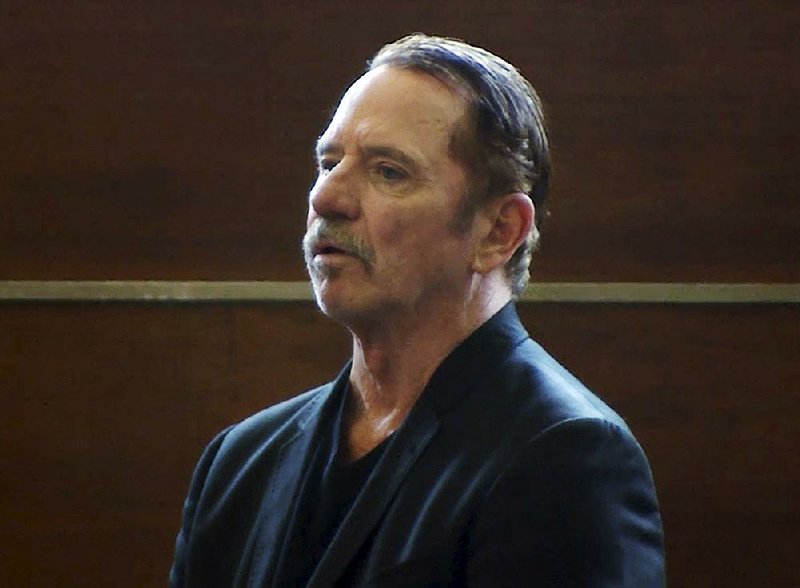 In this still image from video, actor Tom Wopat stands during arraignment Thursday, Aug. 3, 2017, in Waltham, Mass., on indecent assault and battery and drug possession charges. 