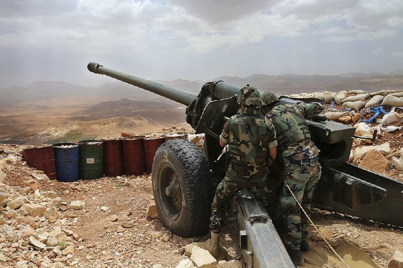 Lebanese soldiers work on a 130mm howitzer cannon aimed at areas controlled by Islamic State group militants near Arsal in June 2016 in northeast Lebanon.  