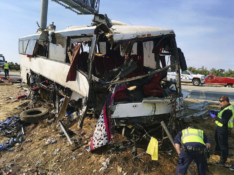 Investigators look at the scene of a charter bus crash on California 99 between Atwater and Livingston in August 2016. U.S. officials are abandoning plans to require sleep apnea screening for truck drivers and railroad engineers. 