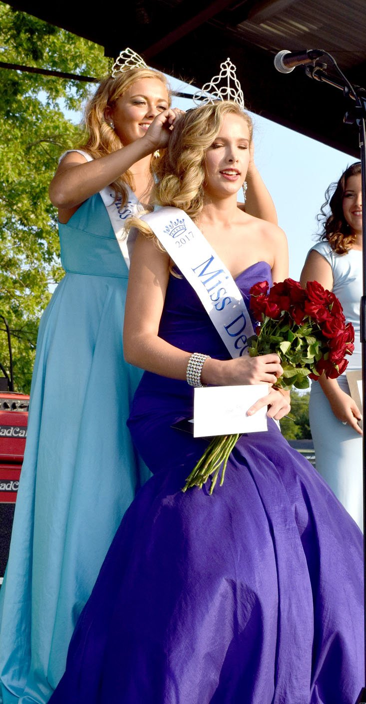 Photo by Mike Eckels Starling Ledbetter (right) from Fayetteville was crowned the 2017 Miss Decatur Barbecue by Sara Garner (also from Fayetteville), the 2016 Miss Decatur Barbecue, during the ceremony on the stage at Veterans Park in Decatur Aug. 5.